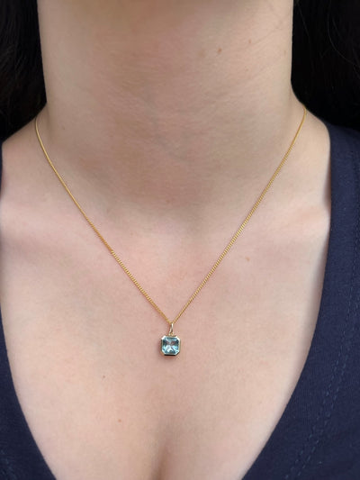 9ct Gold Emerald Cut Blue Topaz Pendant.