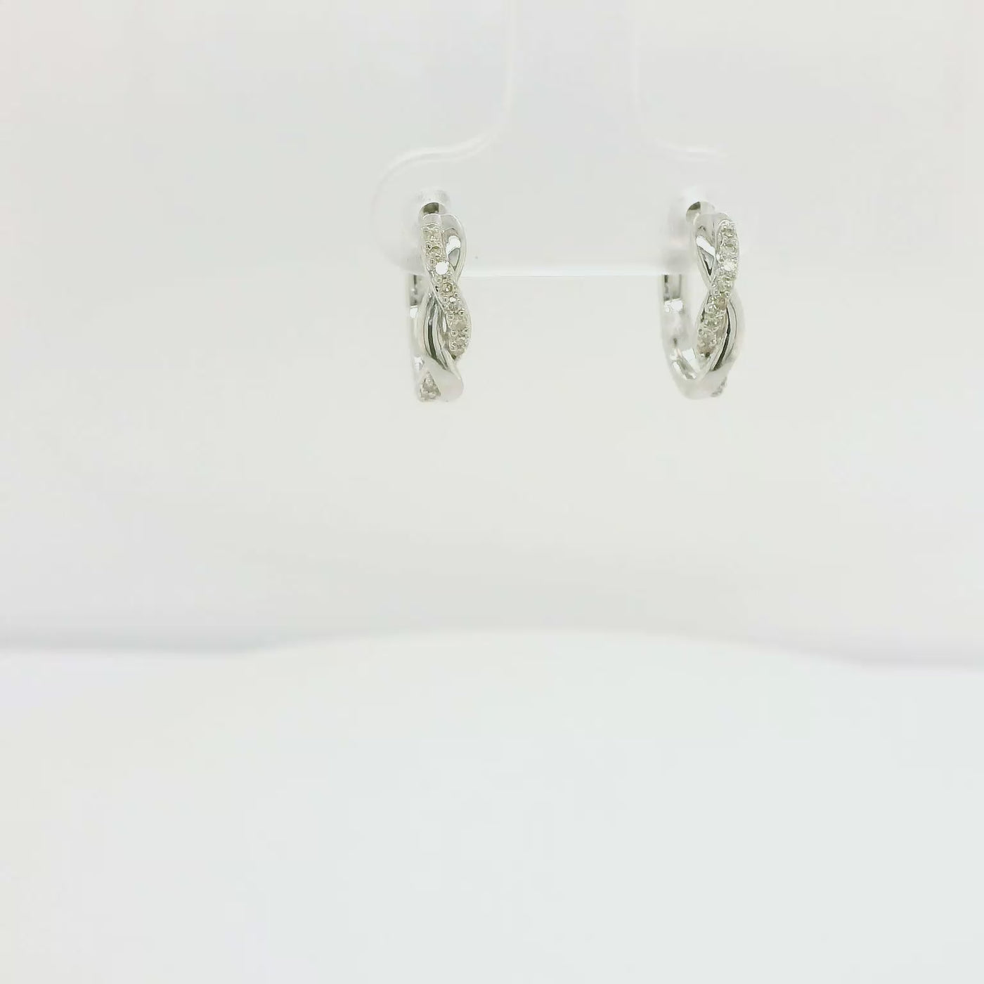 9ct White Gold Infinity Diamond Huggie Earrings.